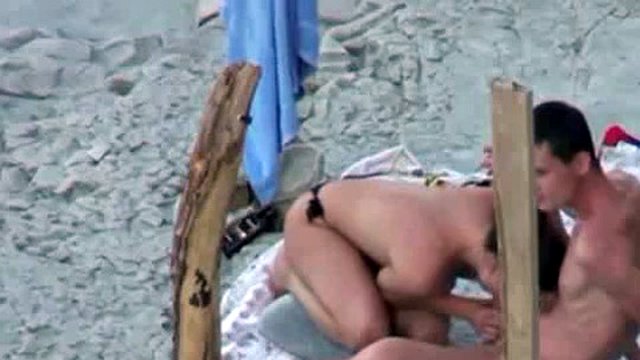 A couple is spying on camera at the beach