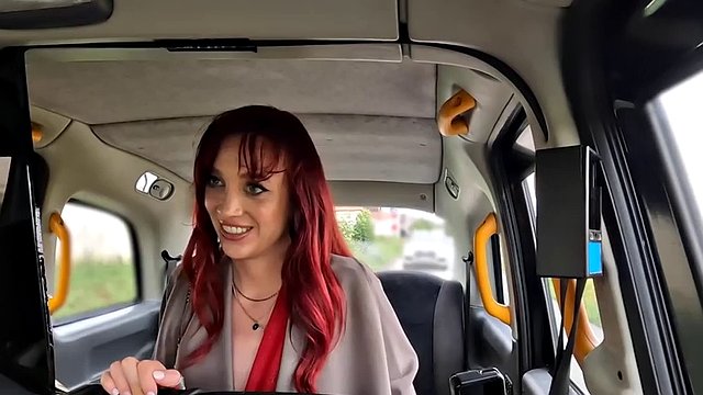 Horny redhead babe rides the taxi driver in his car outdoors