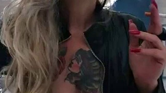 Mistress in leather and latex smokes in your face