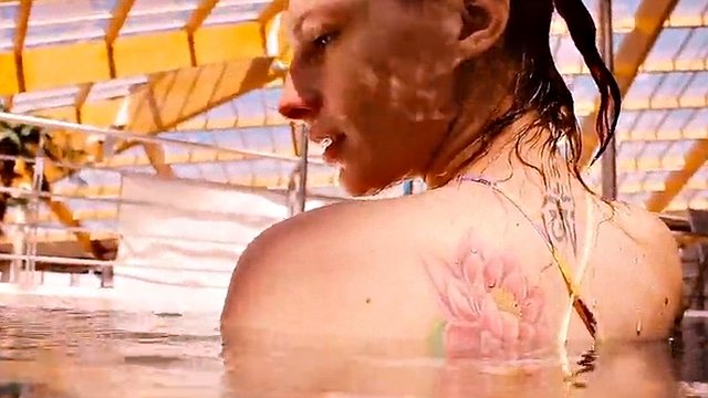 Baby floating in the swimming pool naked