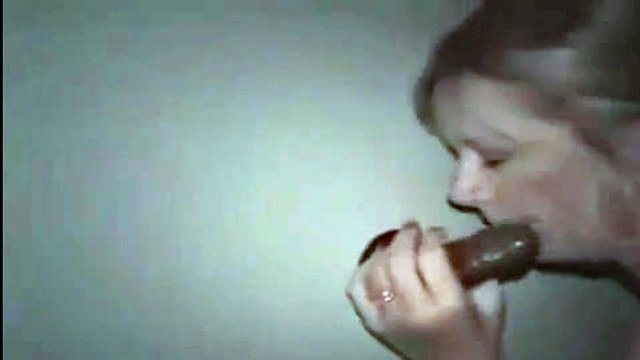 My wife swallows big black cock in the glory hole