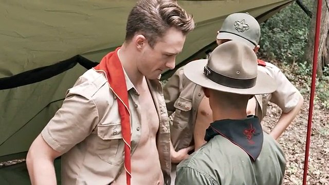 Hottie scout bareback fucks new scouts in a threesome outdoors under a tent