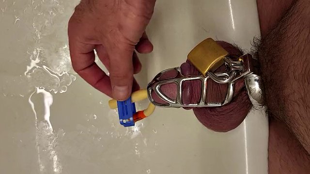 Pissing with a catheter locked in a chastity cage
