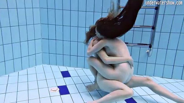 Enjoying underwater lesbian sex with a redhead