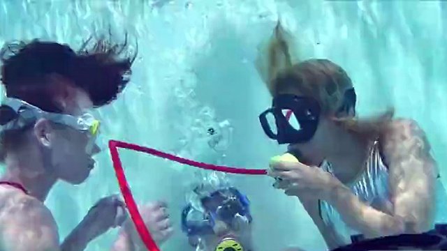 Two hot girls suck a big cock in the pool