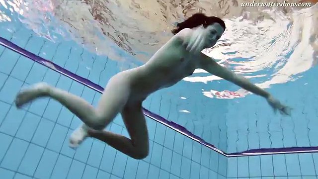 Gypsy girl with dark hair swimming underwater