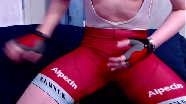 Sexy guy in a bicycle suit plays with himself and cums