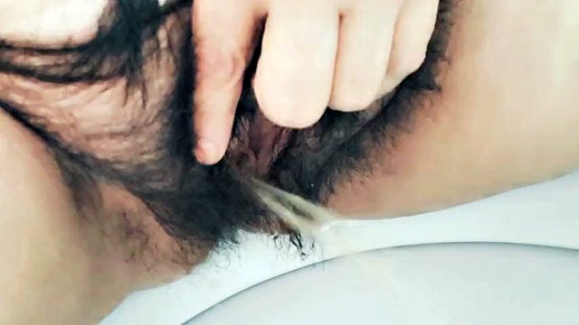 MILF stepmom peeing hairy pussy in bathroom