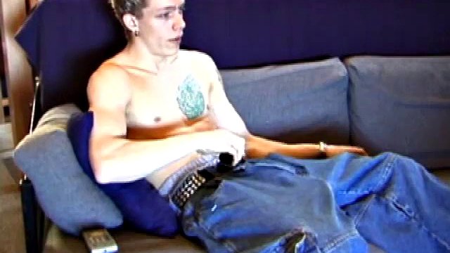 Shane relaxes on the sofa, while watching a porn video and becomes totally himself. He works his lubricated cock with determination and pumps a big load of cum on his shirt.